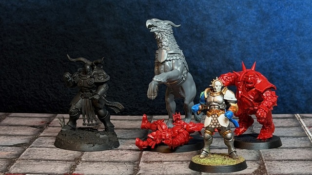 Photo of 4 models lined up to compare size: Rostus Oxenhammer, a gryph charger, a Vindictor and a Blood Bowl ogre