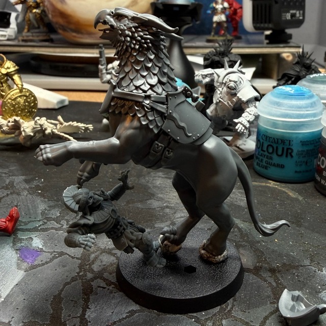 Phot of the gryph-charger model still reared up, this time with a skeleton model ‘falling backwards’ under its raised front paws as if being trampled.