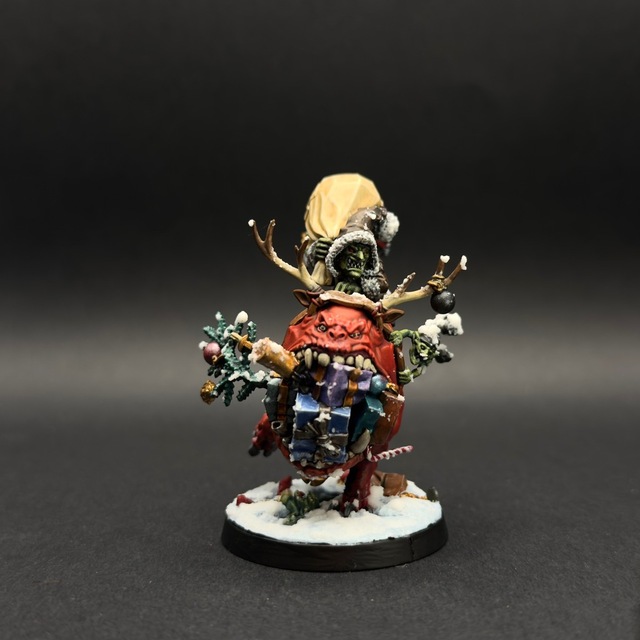 Photo of a fully painted Grotmas Gitz model on a black backdrop