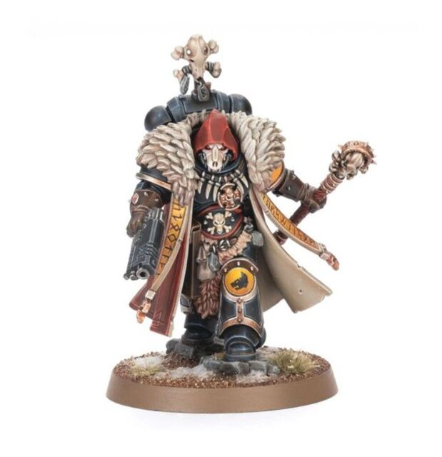 Promo photo of the Space Wolves Wolf Priest. It’s posed striding forward, with flowing cloak and large wolf pelt across the shoulders that might work as a fur collar for a Santa outfit