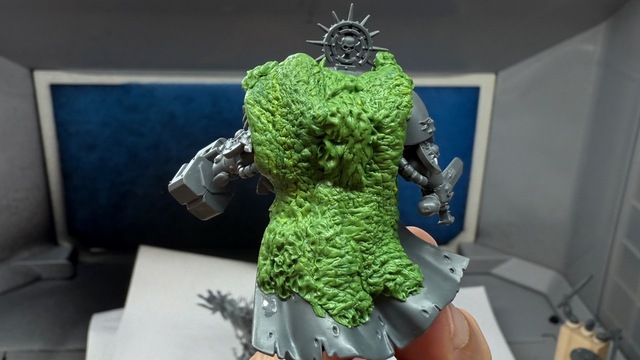 Photograph of the terminator model from behind. Green stuff has been used to create a fur effect down over the shoulders and most of the length of the captain’s cape, with a central section noticeably added on top of the first layer of ‘fur’