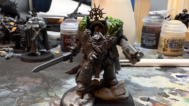 Photo of the terminator captain model, now with a bearded head and the wolf pelt tidied up over his shoulder. The model is also now on a base, standing atop some rocks