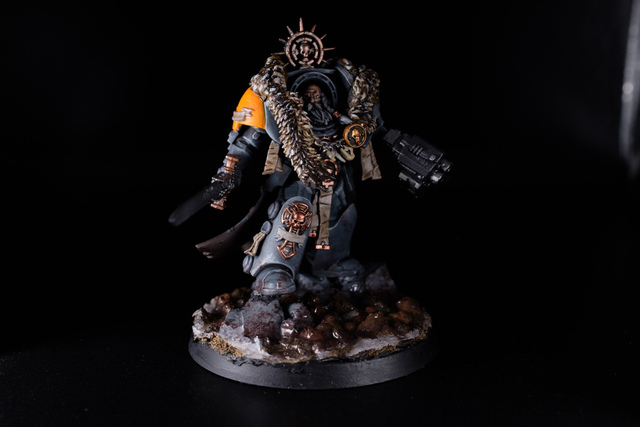 Photo of a mostly-painted Space Wolf terminator captain. A wolf pelt has been moulded over his shoulders and the head swapped for an older face with long beard and moustache, painted grey.